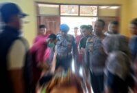 Petugas Polsek Singgahan bersama tenaga medis melakukan pemeriksaan di lokasi kejadian penemuan pria muda yang tewas gantung diri di Desa Tingkis, Kecamatan Singgahan, Tuban, Minggu (09/11/2025), (Assayid Annazili/Liputansatu.id).