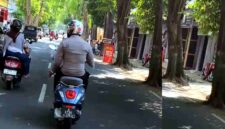 Anggota Polsek Singgahan terekam mengendarai sepeda motor sambil mengenakan seragam dinas di Jalan Basuki Rahmat, Tuban, (Assayid Annazili/Liputansatu.id).